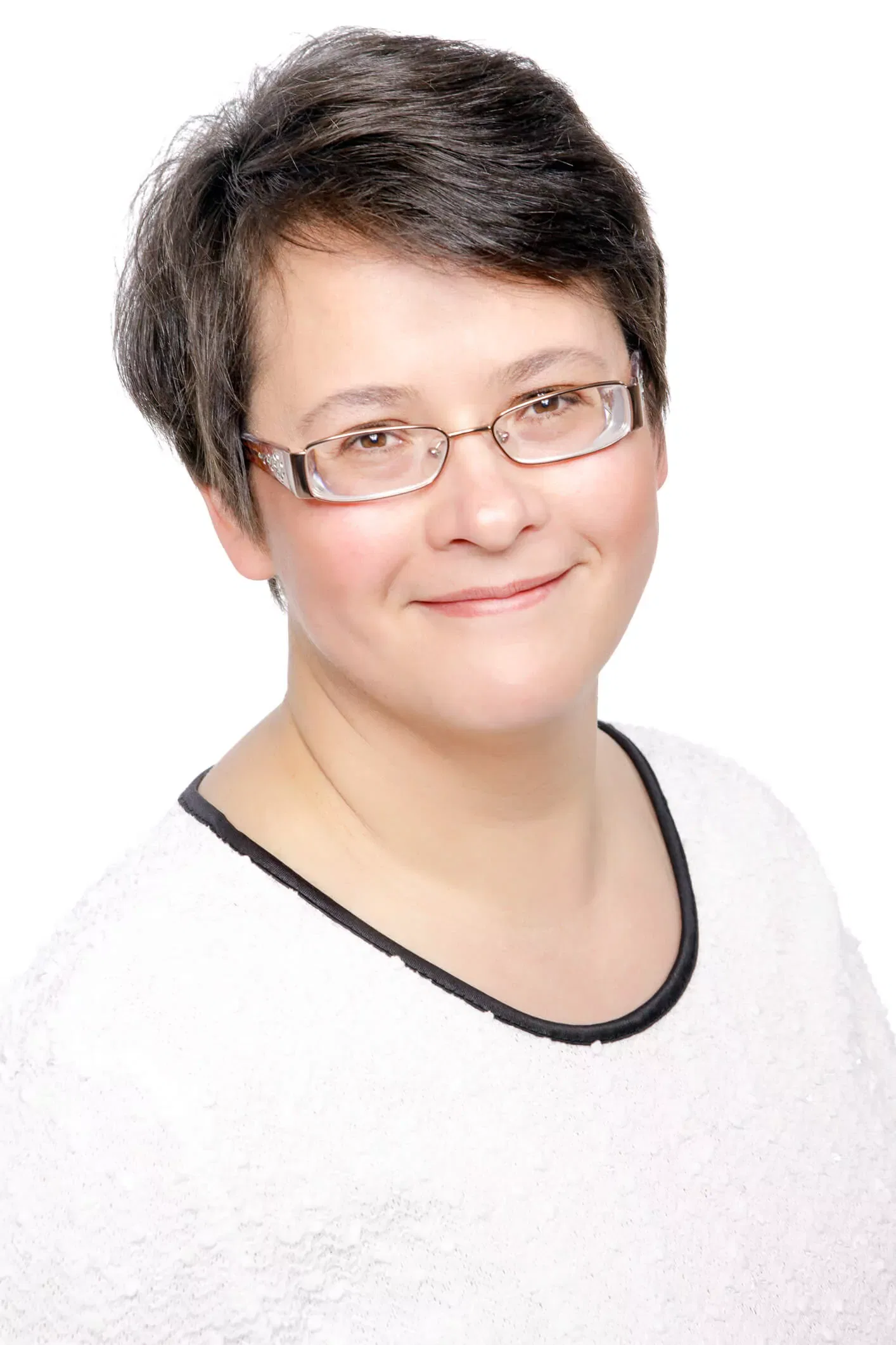 Portrait of a person wearing glasses and a white top, representing Elna Esterhuizen Counselling services.